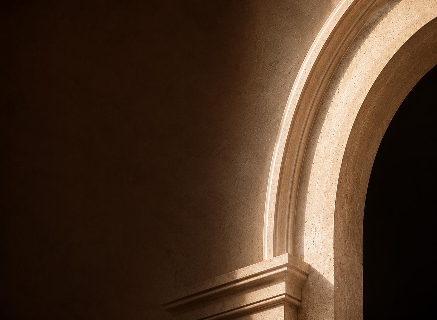 Cream stone arch illuminated by grazing afternoon light